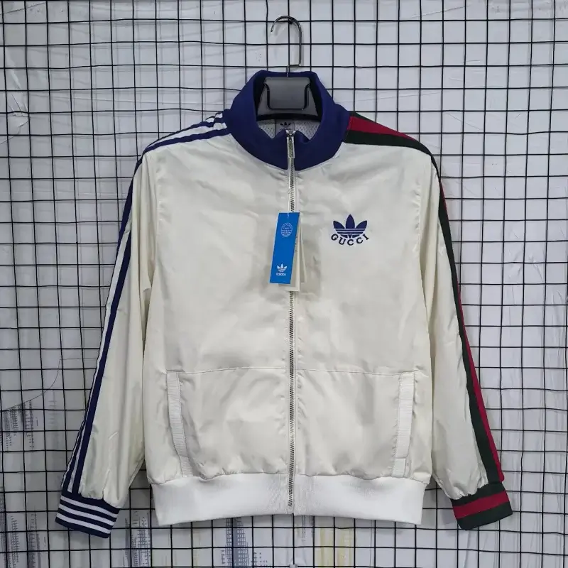 Corteiz White Track Jacket with Striped Sleeves, Zipper, Pockets & Trefoil Logo